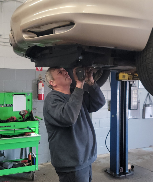 Awto Works Complete Auto Repair technician inspecting car