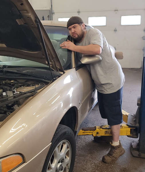 Awto Works Complete Auto Repair technician working on car
